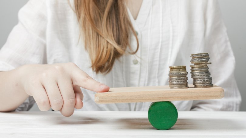 woman-holding-her-finger-balance-with-coins